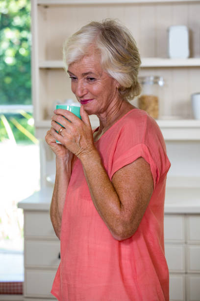 istock Thoughtful senior woman having coffee in kitchen 667661038