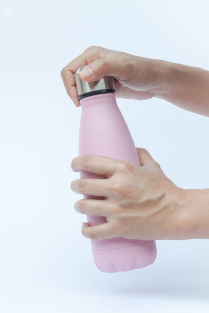 istock Woman hand holding warm bottle isolated on white background 667661744