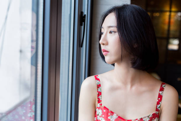 istock young attractive woman sitting on windowsill in restaurant 667661828