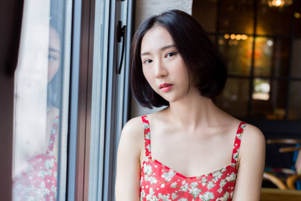 istock young attractive woman sitting on windowsill in restaurant 667664038