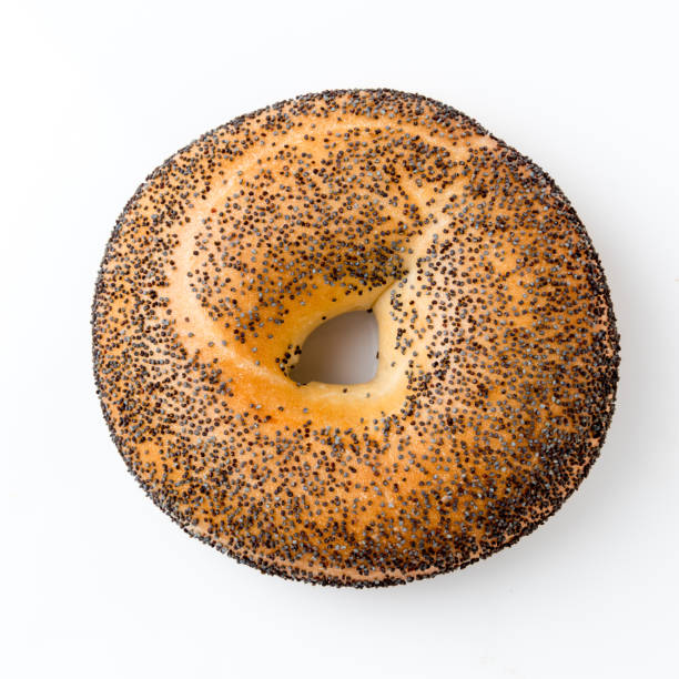 Poppy Seeds Organic Bagel poppy seeds organic Bagel on white background poppy seed stock pictures, royalty-free photos & images
