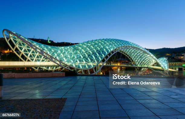 Bridge Of Peace At Night In Tibilisi Georgia Stock Photo - Download Image Now - Bridge - Built Structure, Georgia - Country, Symbols Of Peace