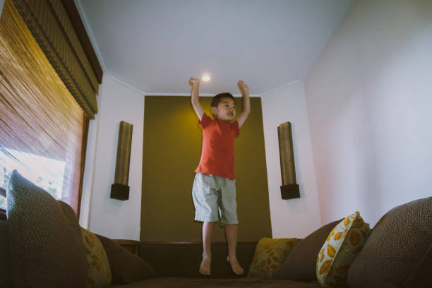istock Cute boy jumping on tatami sofa 667672240