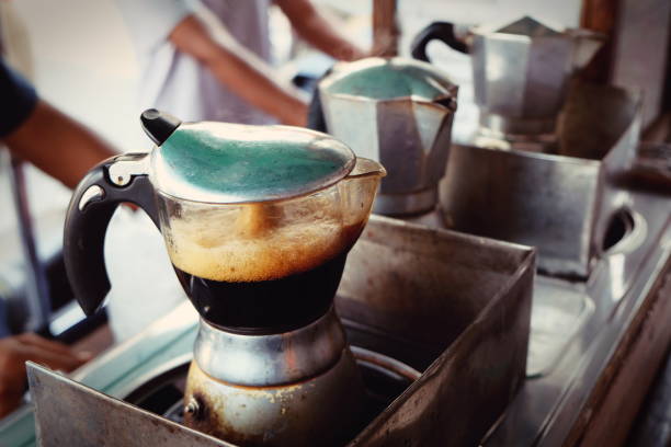 moka pot Italian traditional coffee maker with hot coffee - fotografia de stock