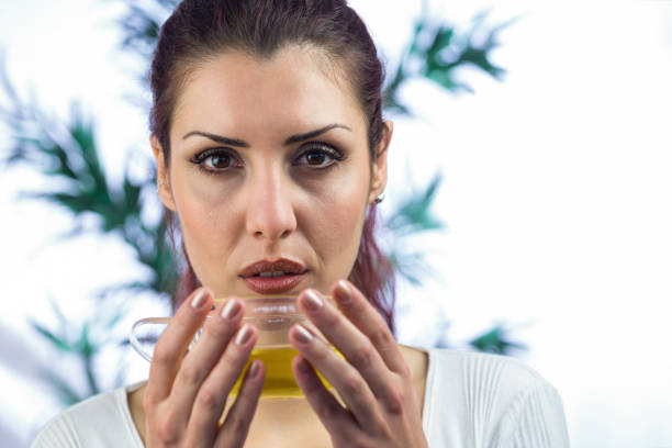 istock Confident woman holding herbal tea 667678726