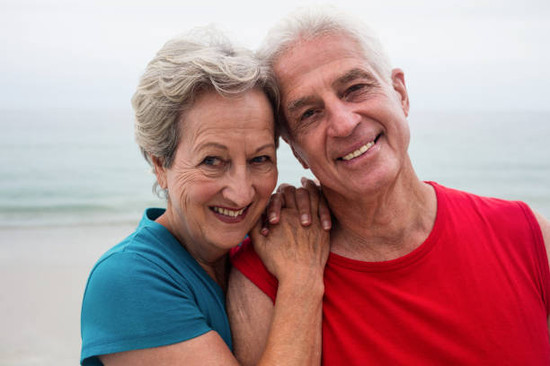 istock Happy senior couple embracing each other on the beach 667679936