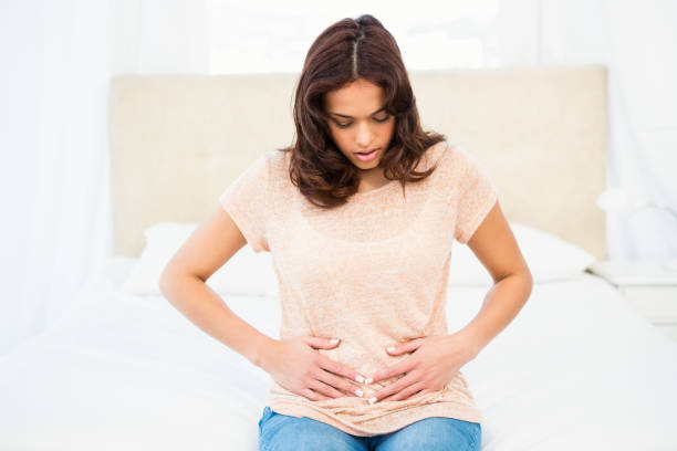 istock Casual smiling woman touching her belly 667682164