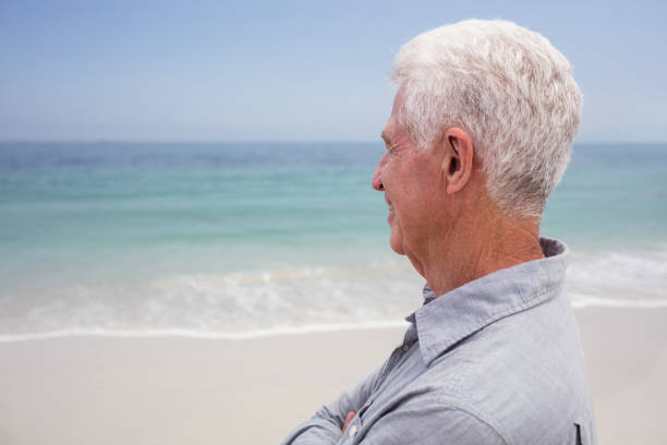 istock Happy senior man looking at sea 667685540