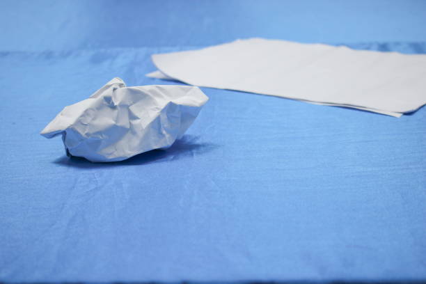 istock Crumpled paper lump and texture on blue table background 667686590