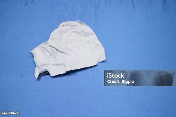Crumpled Paper Lump And Texture On Blue Table Background Stock Photo - Download Image Now