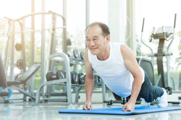 istock Asian senior man push up at the gym. copy space. 667690450
