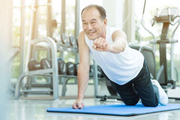 istock Asian senior man push up at the gym. copy space. 667690464