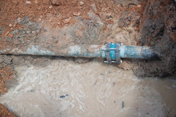istock repair the plumbing broken pipe and water flow in hole. 667701344