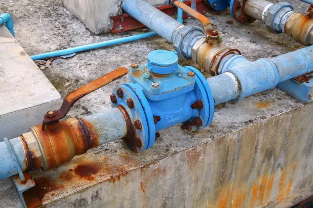 Photo of water valve plumbing joint  steel rust industrial old  tap pipe