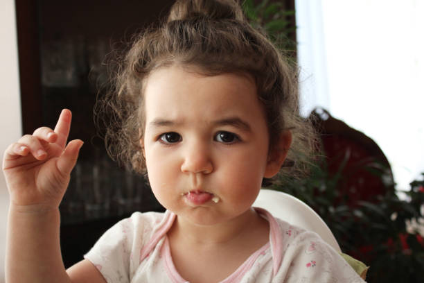 istock baby portrait with hand raised 667704686