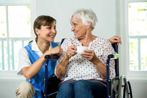 istock Smiling senior woman with nurse 667704716