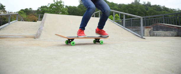 istock skateboarder legs doing a ollie trick at skatepark 667704766