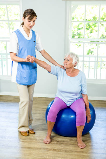 istock Senior woman exercising with nurse 667707500