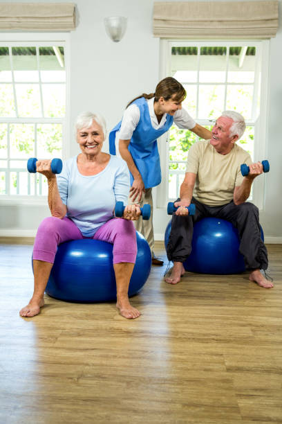 istock Senior man and woman holding dumbbellls 667708298