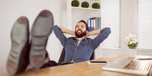 istock Hipster businessman relaxing at his desk 667708926