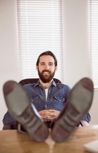 istock Hipster businessman relaxing at his desk 667708980