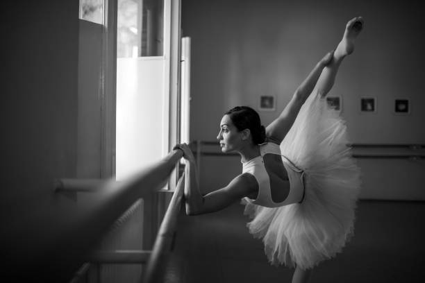 istock Young ballerina stretching at ballet dance studio. 667709116