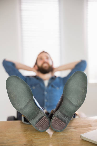 istock Hipster businessman relaxing at his desk 667709218