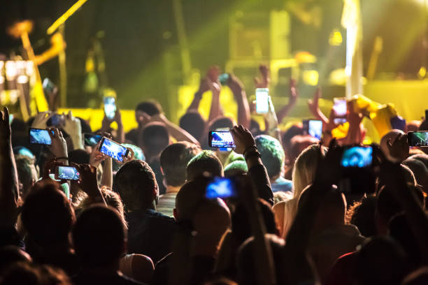 Crowd at concert and blurred stage lights . stock photo