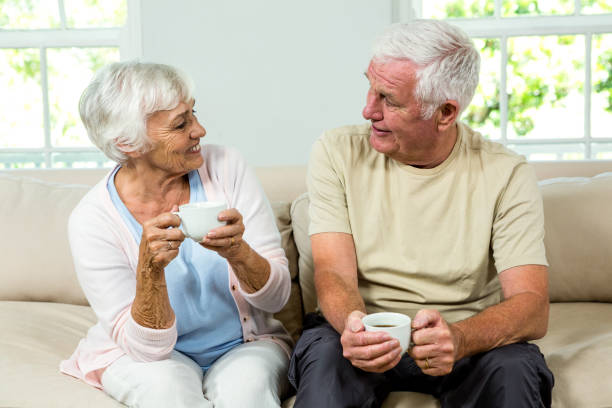 istock Senior man and woman sitting on sofa 667709666