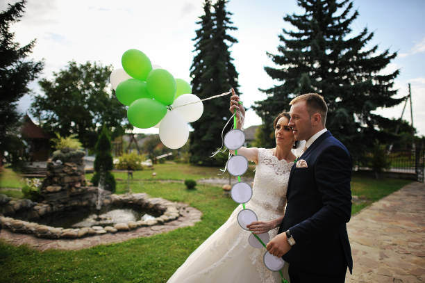 istock Happy wedding couple with balloons 667709694