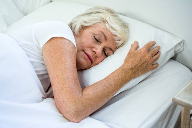 istock High angle view of aged woman sleeping 667712126