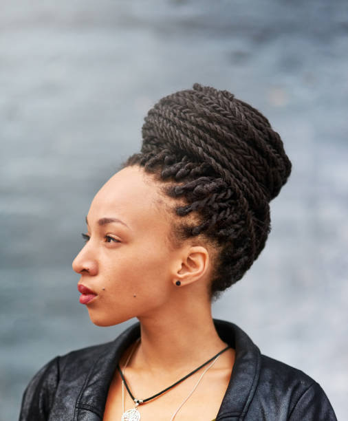 Looking beautiful in her braided bun Shot of an attractive young woman with a braided bun posing outdoors black woman hair braids stock pictures, royalty-free photos & images