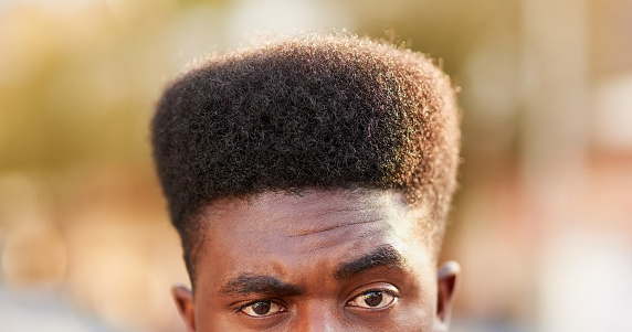 Portrait of a young man with high top fade posing outdoors