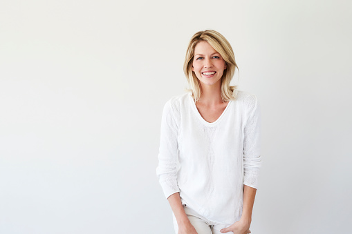 Blond and beautiful woman in white fashion