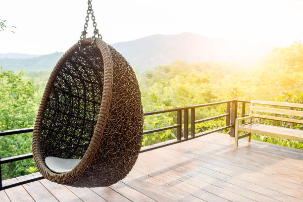 istock Rattan lounge hanging chair with white  pillow 667719670