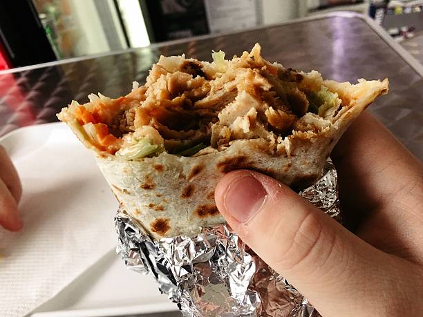 istock Cropped Image Of Person Eating Wrap 667719707
