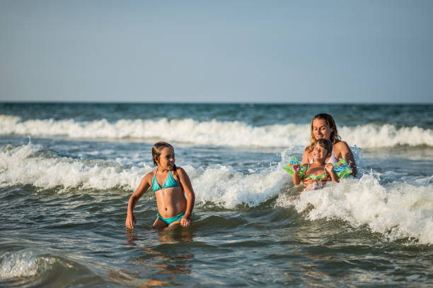 istock Family splashig in sea waves 667719934