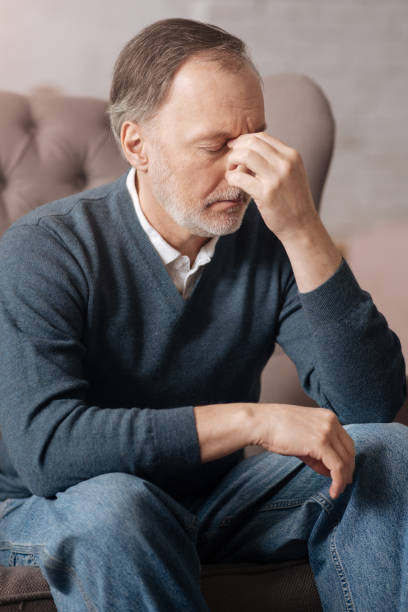 istock Close up of senior man with terrible headache 667719936