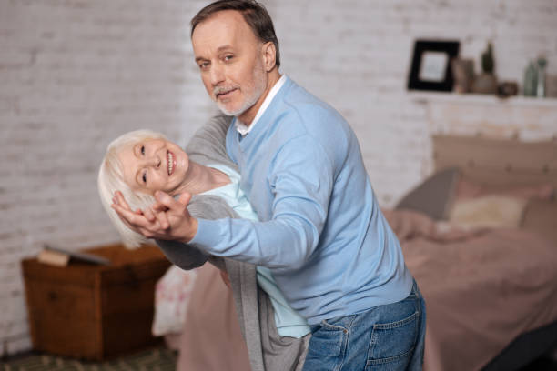 istock Aged man and woman are dancing together 667734018