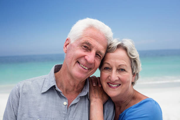 istock Happy senior couple embracing each other on the beach 667734216
