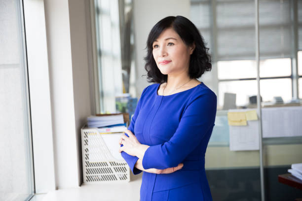 istock middle-aged female manager posing near by window 667735436