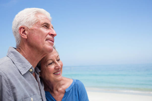 istock Senior couple embracing each other on the beach 667737860