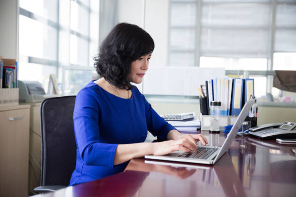 istock middle-aged female manager working in office 667738408