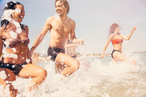 istock Friends going into the sea 667743928