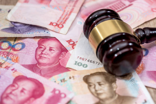 istock yuan on wooden hammer . close up. 667747832