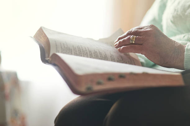 Faith comes first Closeup shot of an unrecognisable woman reading a bible church ladies stock pictures, royalty-free photos & images