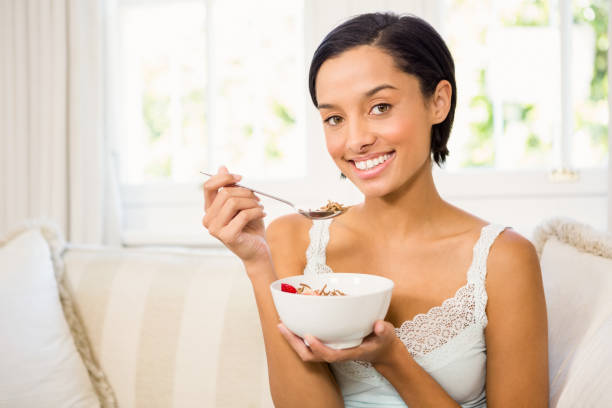 istock Attractive brunette eating cereals 667748266