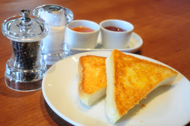 istock Bread with butter and jam on wood table 667748864