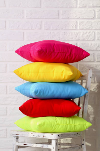 istock Colorful pillows on chair on white brick wall background 667749062