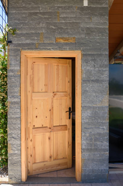 istock Wooden door on stone brick wall 667751544